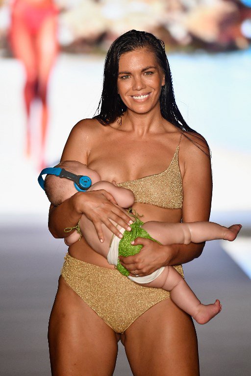 Model breastfeeds baby on catwalk