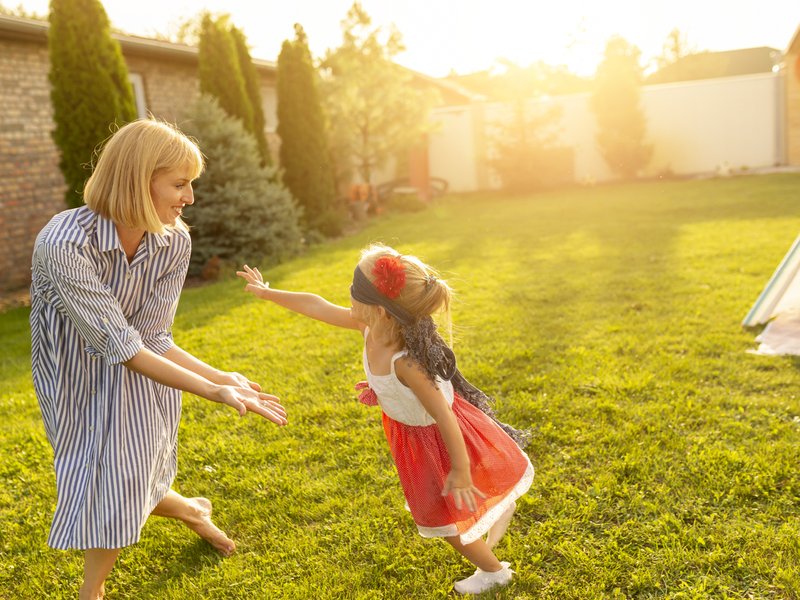Mom and child playing in the sun