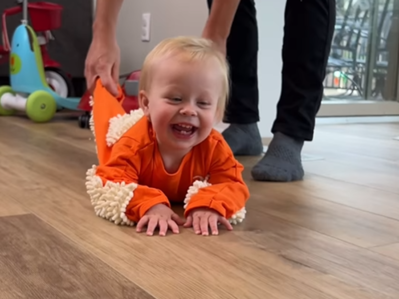 Mom plays with baby on the floor
