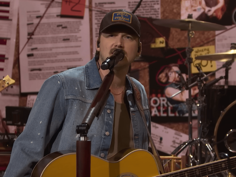Morgan Wallen wearing a denim jacket while performing