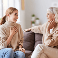 Mother and daughter speaking on couch