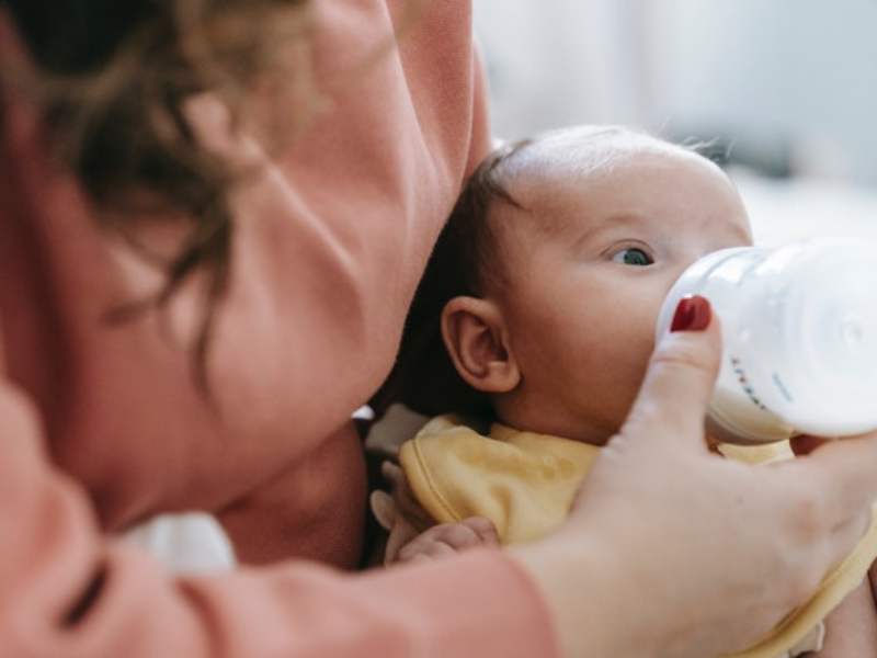 Mother feeding baby bottled milk