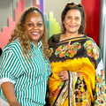 Carol Ofori standing with Veetha Sewkuran in East Coast Radio studios