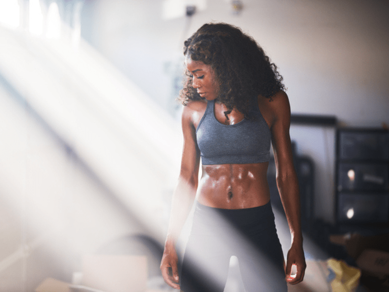 Muscular woman sweating from work out