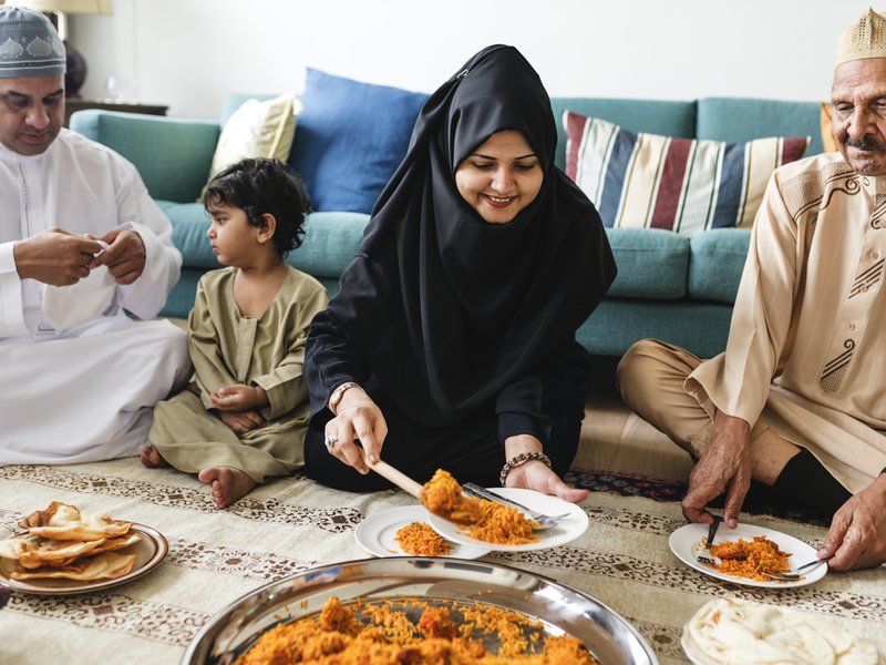 Muslim family having dinner on the floor