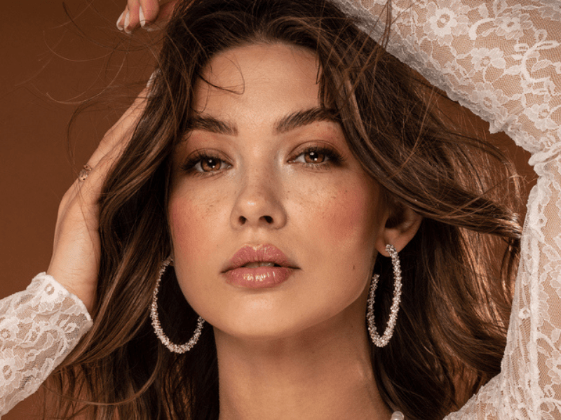Woman with freckles and delicate makeup