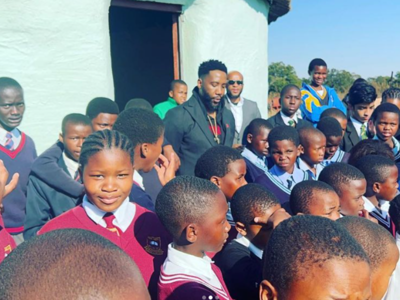 Ndaba Mandela and school children pray this Mandela Day