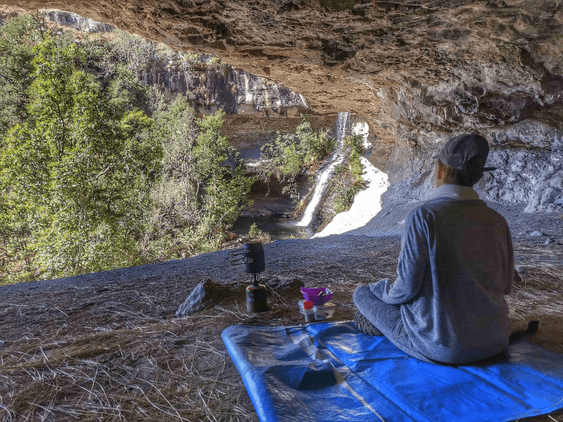 Woman sitting inside a cave