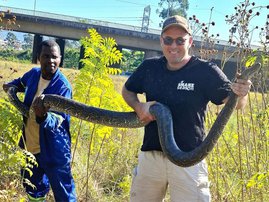 Nick Evans holding python