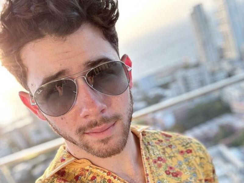 Nick Jonas wearing floral shirt