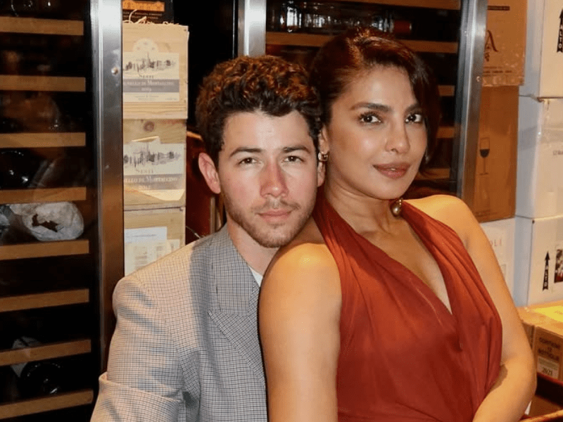 Priyanka Chopra and Nick Jonas pose in a wine cellar