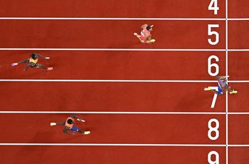 US athlete Noah Lyles crosses the finish line