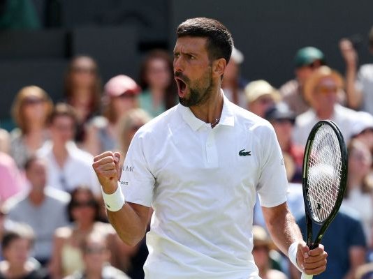 Novak Djokovic reacts as he plays against Britain's Daniel Evans during their second round tennis match on the fourth day of the 2025 Wimbledon Championships