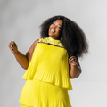 A cheerful Ntokozo Mbambo poses in a yellow dress