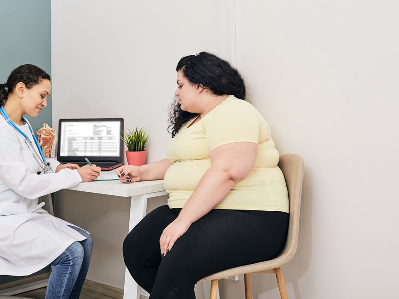Obese woman sitting with doctor
