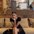 Olivia Dean sitting in a room with vintage books