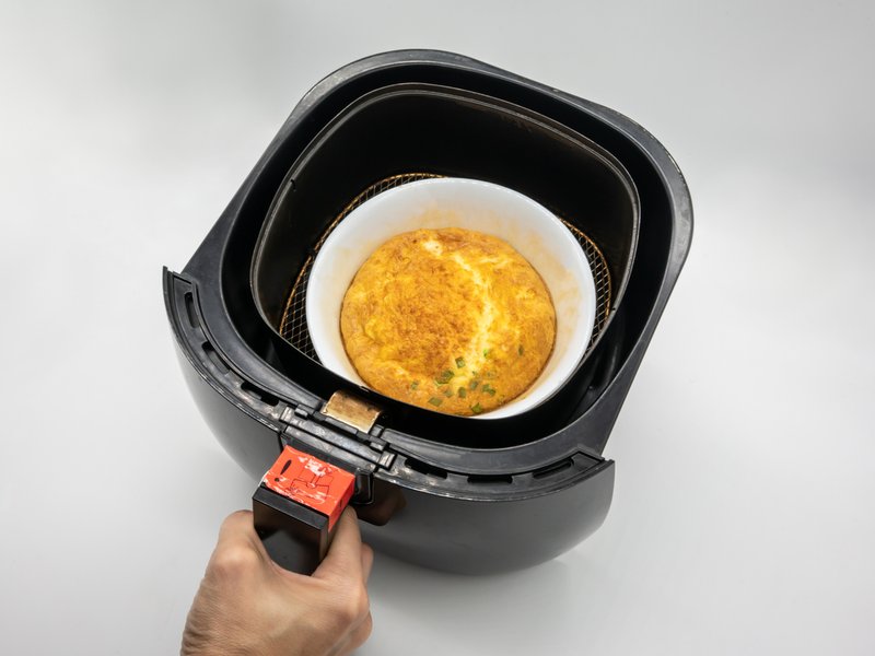 Omelet in white ceramic bowl within black air-fryer istock