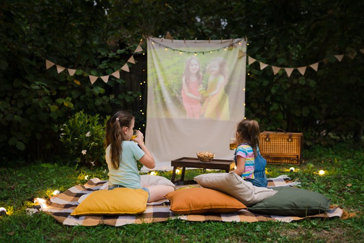 Open air backyard movie night with two young kids