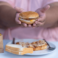 Overweight woman eating junk food