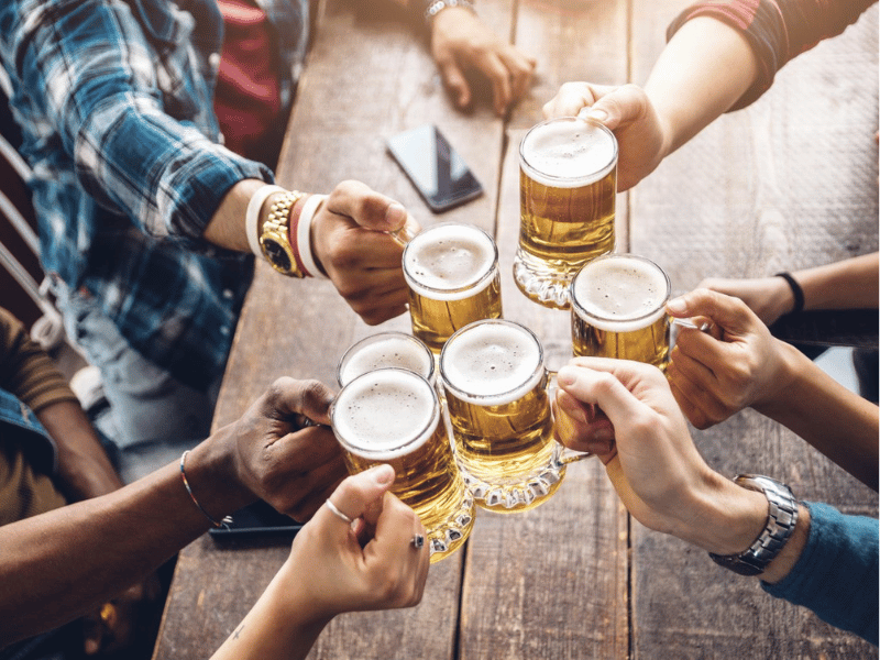 People enjoying and toasting a beer in brewery pub