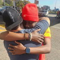 PETROL ATTENDANT AND MAN HUGGING