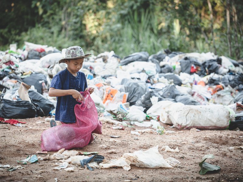 POVERTY BOY PICKING UP GARBAGE