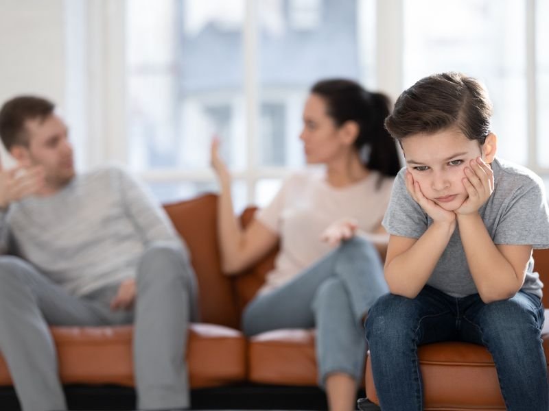 Parents arguing with kid in front of them