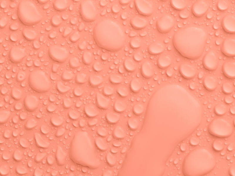 Peach coloured background with water drops