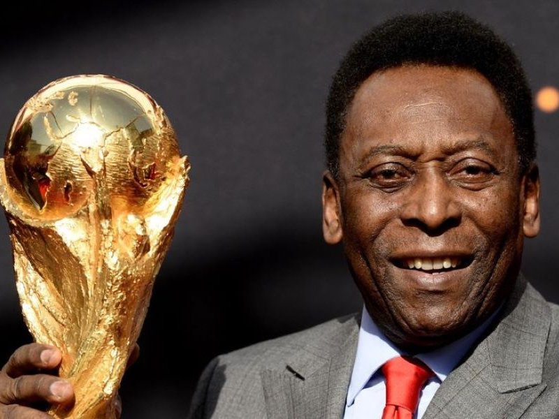 In this file photo taken on March 09, 2014, Brazilian football legend Pele poses with the FIFA World Cup trophy during a press conference, outside the Hotel de Ville in Paris. The hospital treating Brazilian football great Pele announced on December 21,