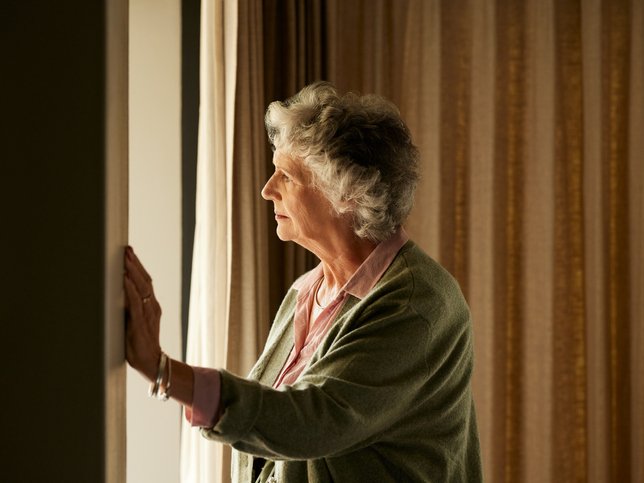 Pensive senior woman at home thinking