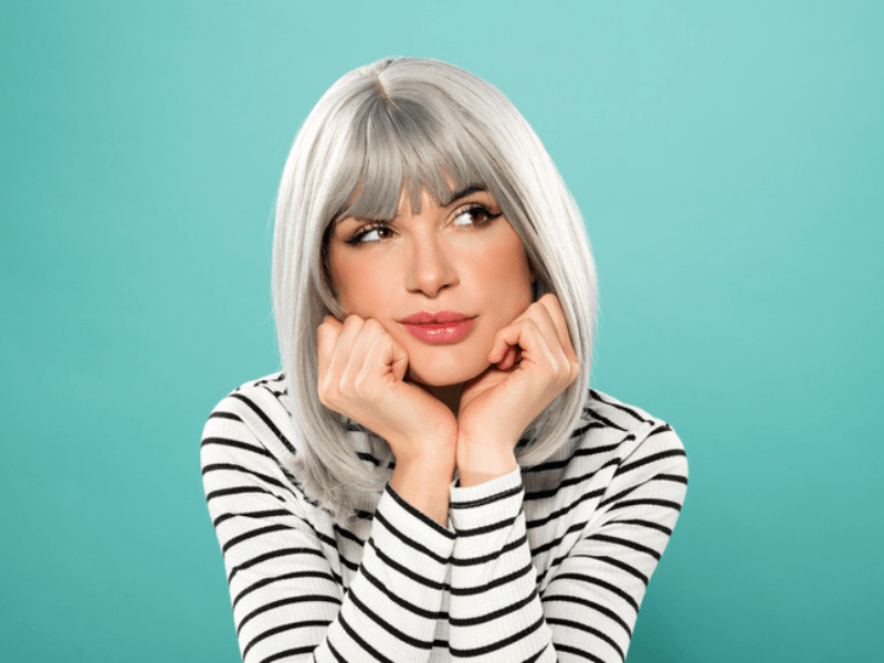 Young woman wearing a grey wig