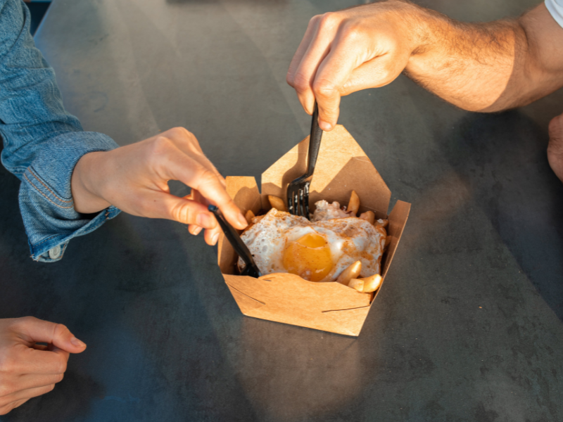 People eating food from a takeout box