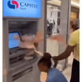People grabbing money from a Capitec ATM