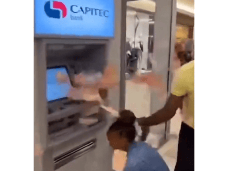 People grabbing money from a Capitec ATM