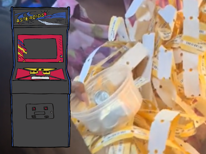 People holding arcade game tickets in their hands