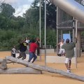 People run in a park as they see a child falling