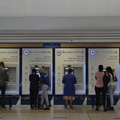 People using Standard Bank ATMs in a public space