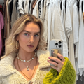 Perrie Edwards takes a selfie in a clothing store