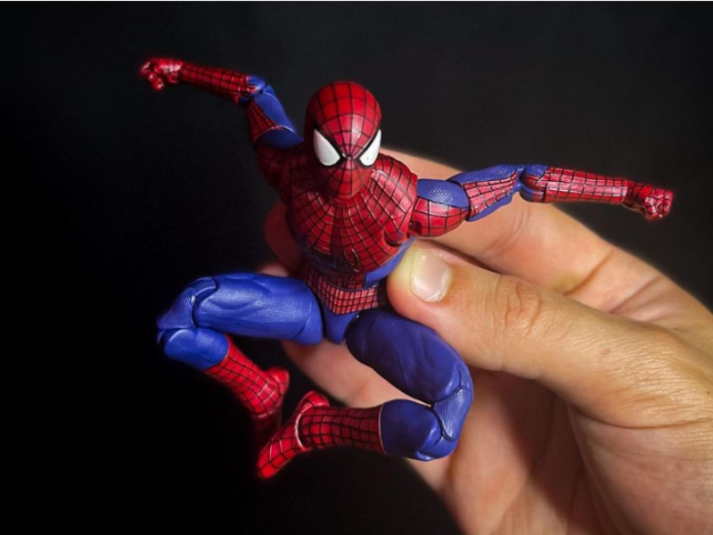 Person holding Spider-Man figurine
