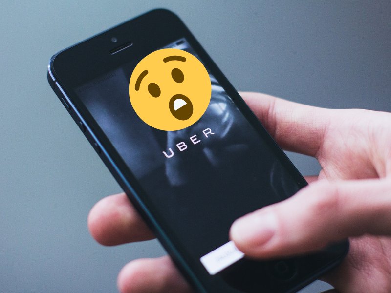 Person holding a smartphone with Uber app open