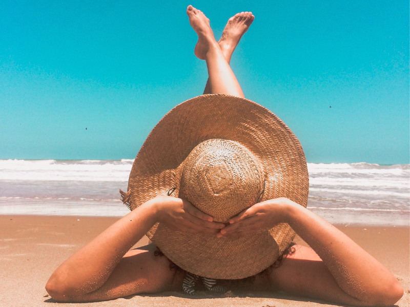 Person laying on sand at beach