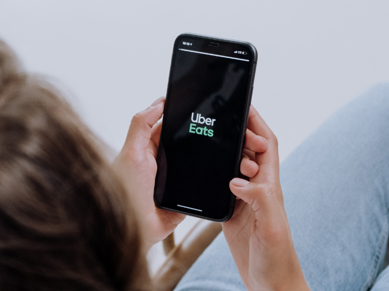 Person using a smartphone with UberEats app open