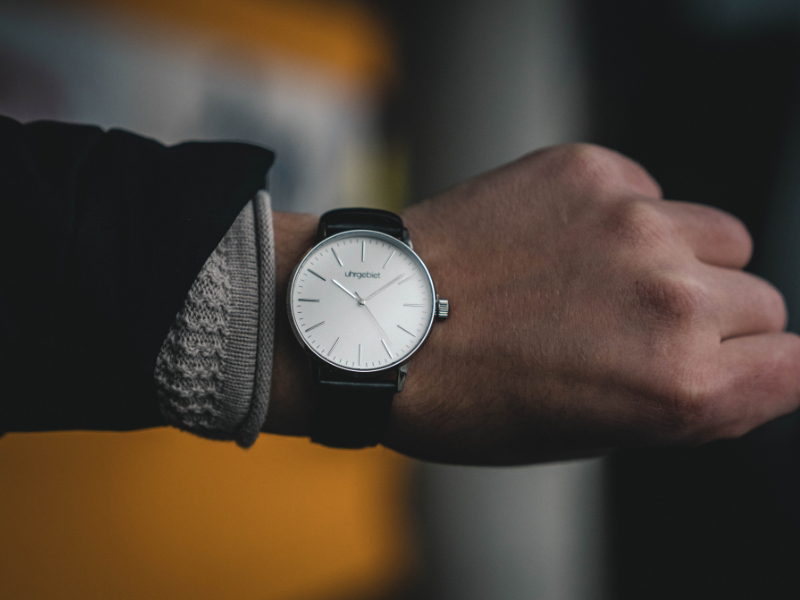 Person wearing round white analog watch
