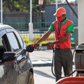Petrol attendant filling fuel