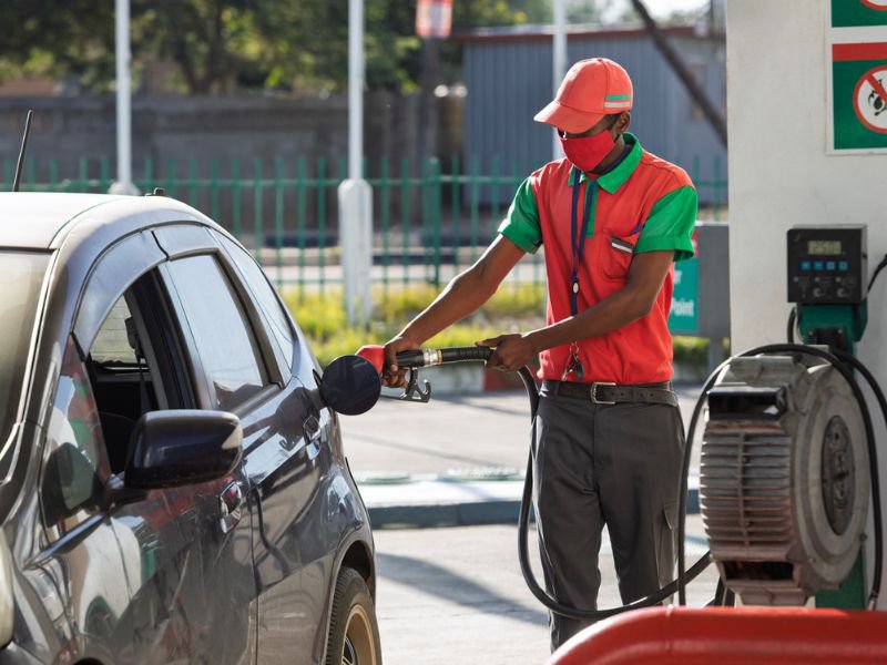 Petrol attendant filling fuel