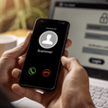 Hands holding phone with incoming call from scammer