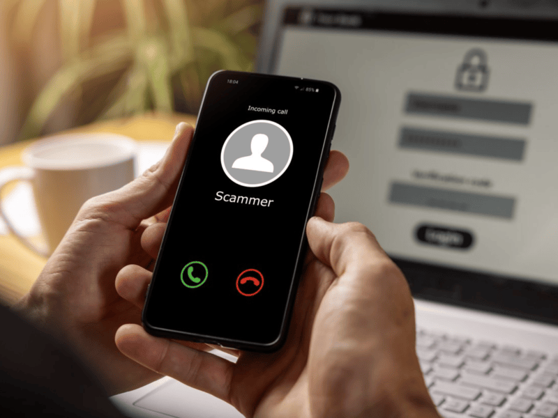 Hands holding phone with incoming call from scammer