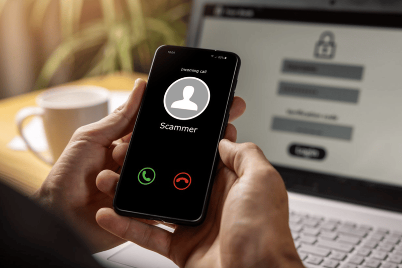Hands holding phone with incoming call from scammer