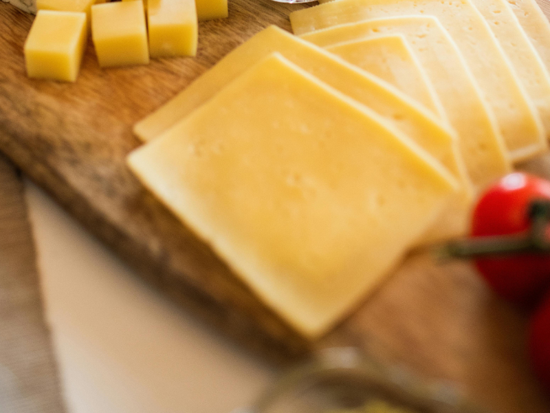 Photo of cheese on wooden tray