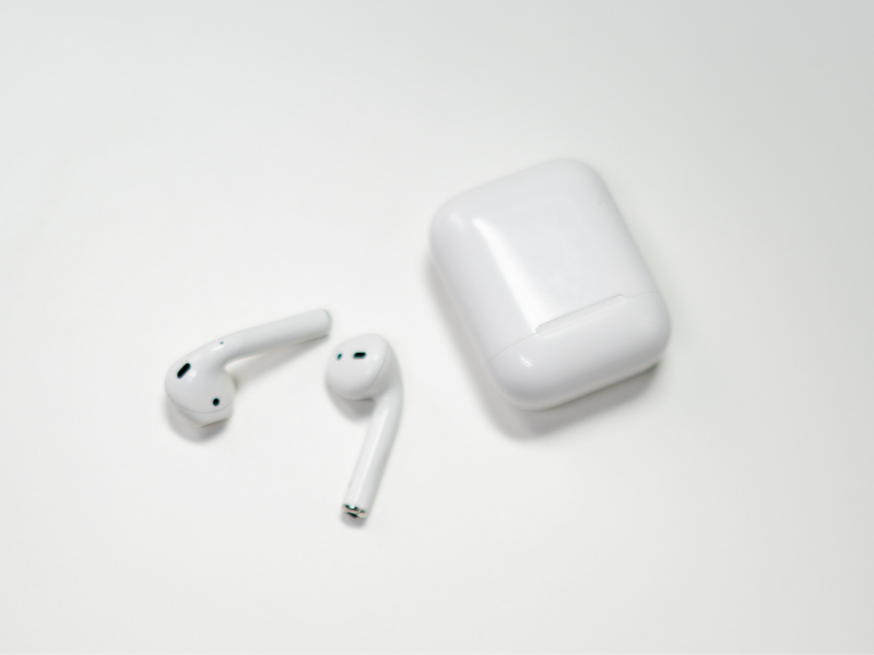 Photo of white earbuds on white surface